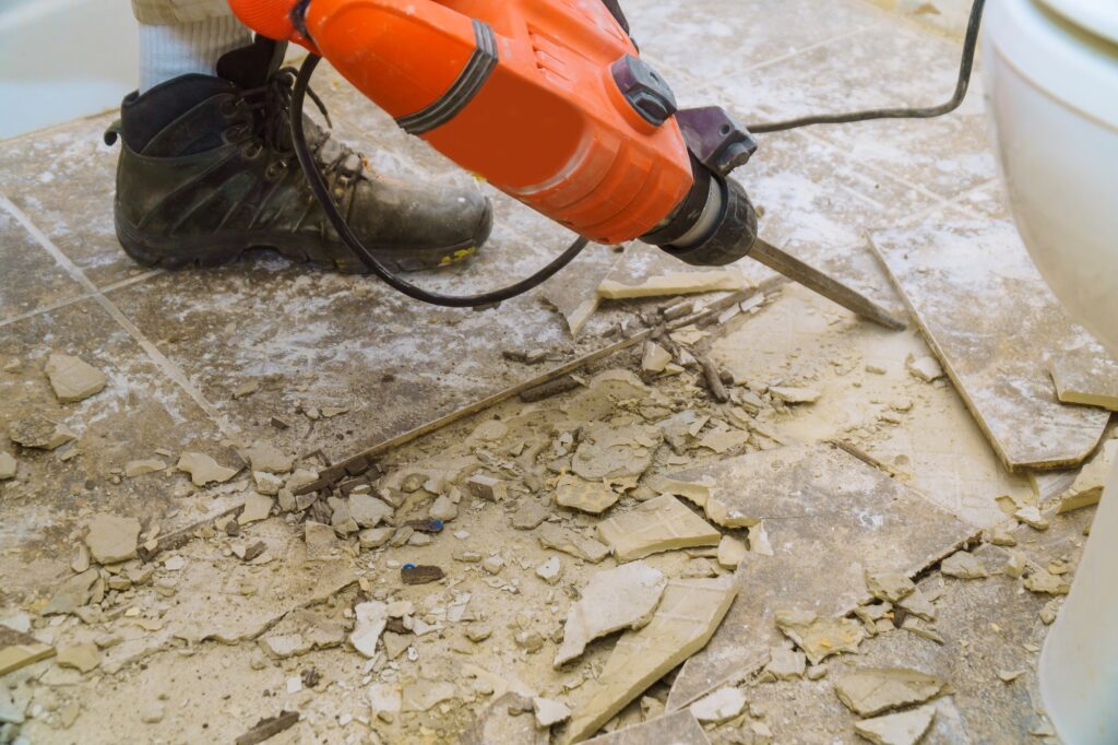Renovation of old floor demolition old tiles with bath jackhammer